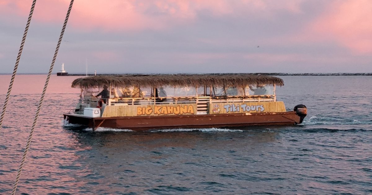 Big Kahuna tiki boat cruising the Buffalo waterfront at sunset