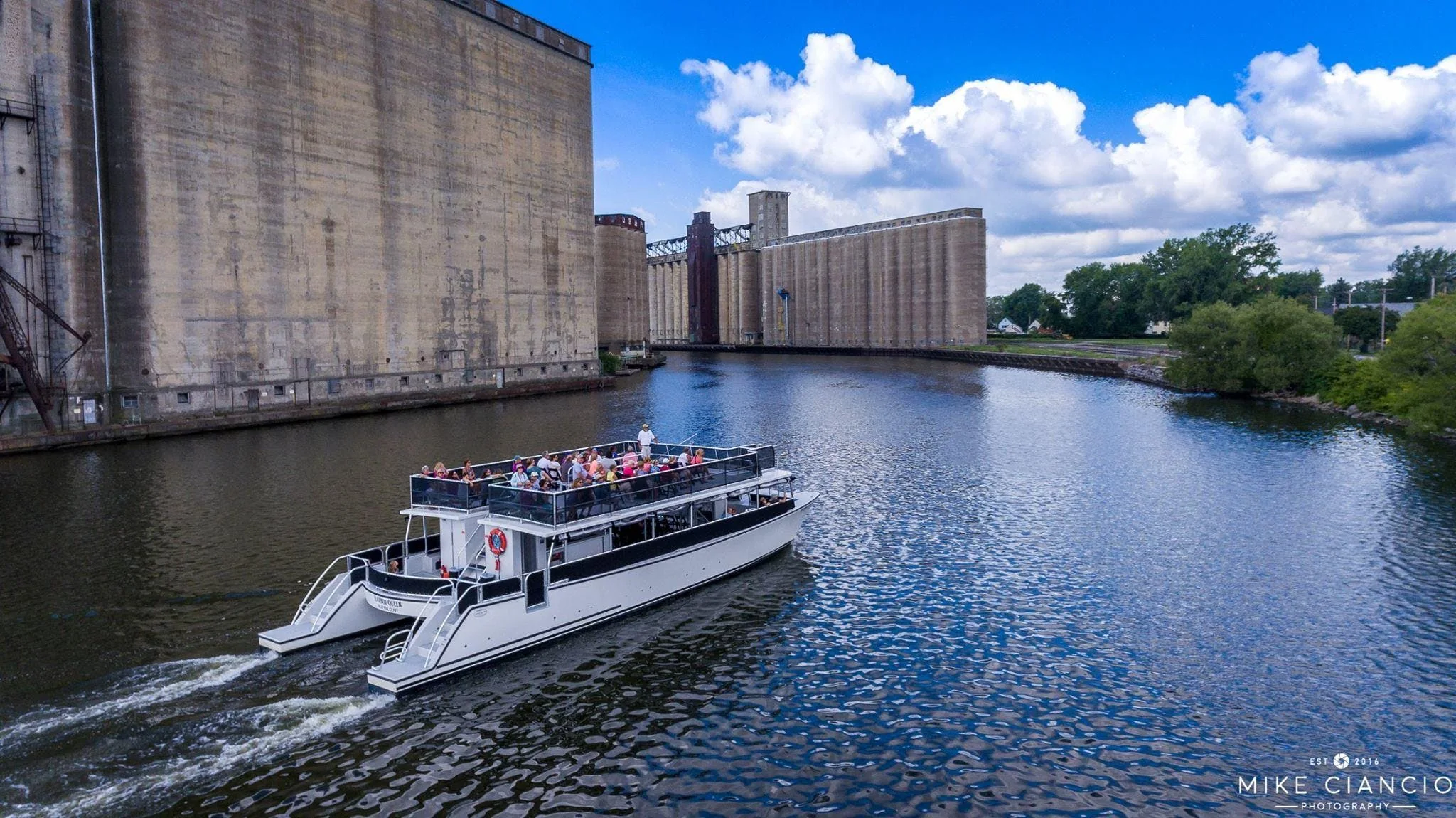 Harbor Queen cruising beside Buffalo grain elevators
