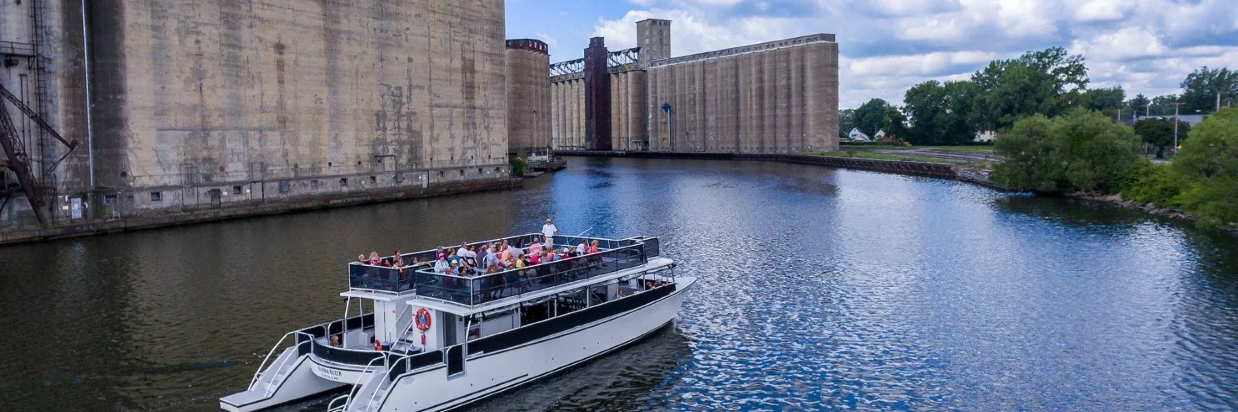 Harbor Queen cruising past Buffalo grain elevators